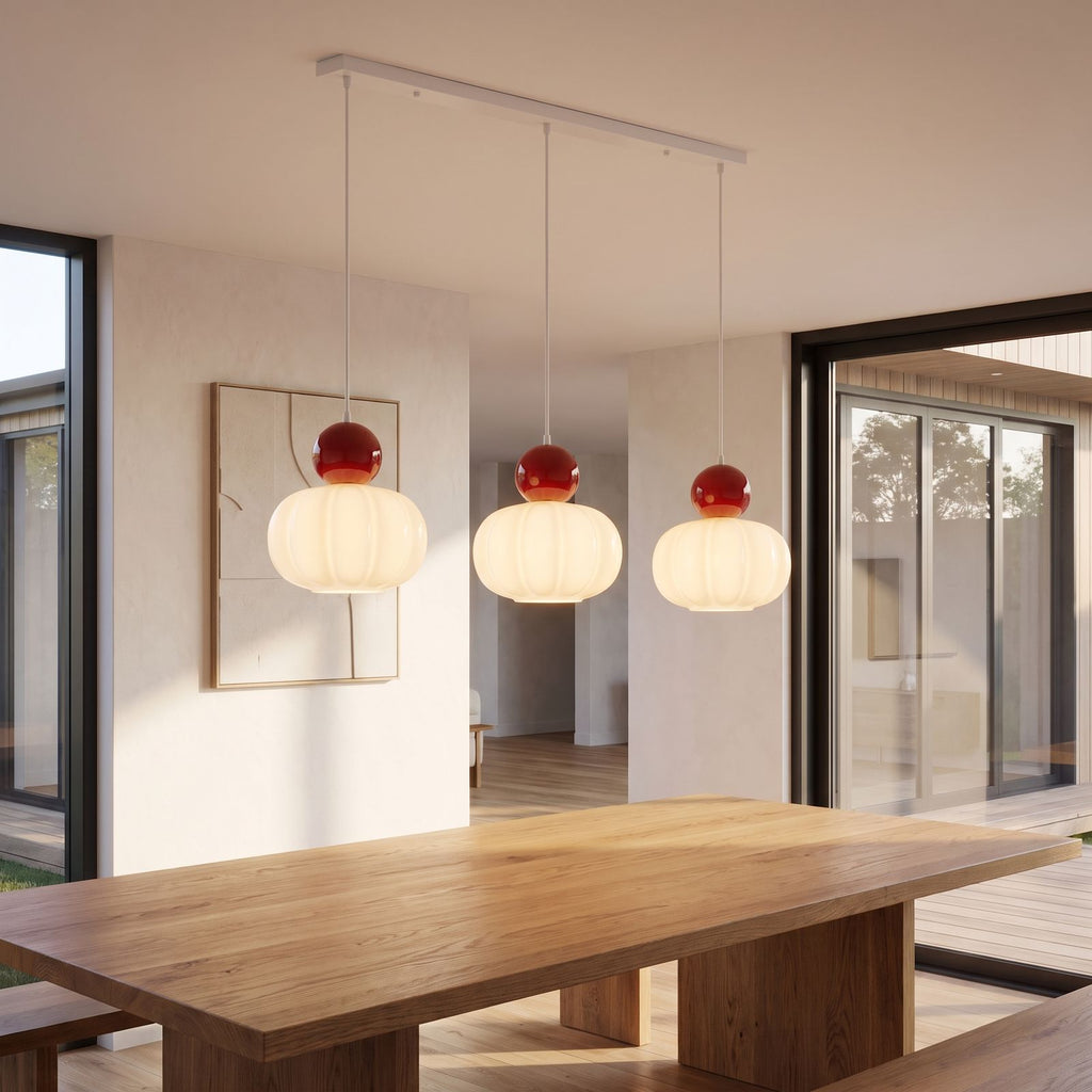 Ball-top scalloped acrylic 3-light pendant above a dining table in daylight
