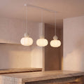 Ball-Top Scalloped Acrylic 3-Light Pendant Light with sand balls over a kitchen island