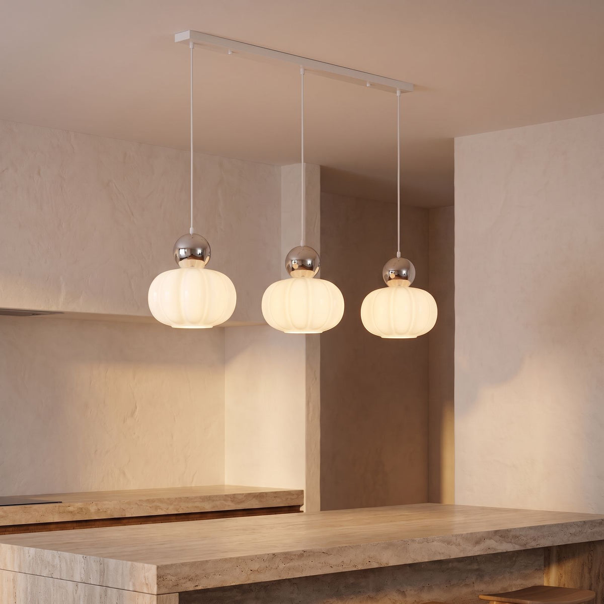 Ball-Top Scalloped Acrylic 3-Light Pendant Light with silver balls over a kitchen island
