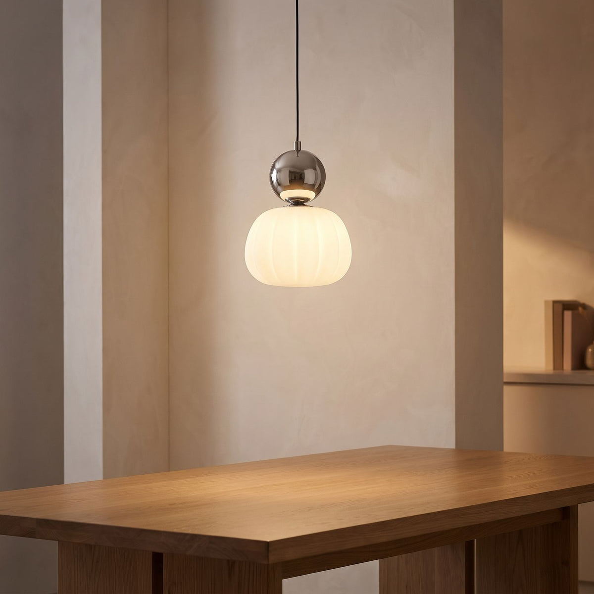 Ball-Top Scalloped Acrylic Pendant Light above a dining table