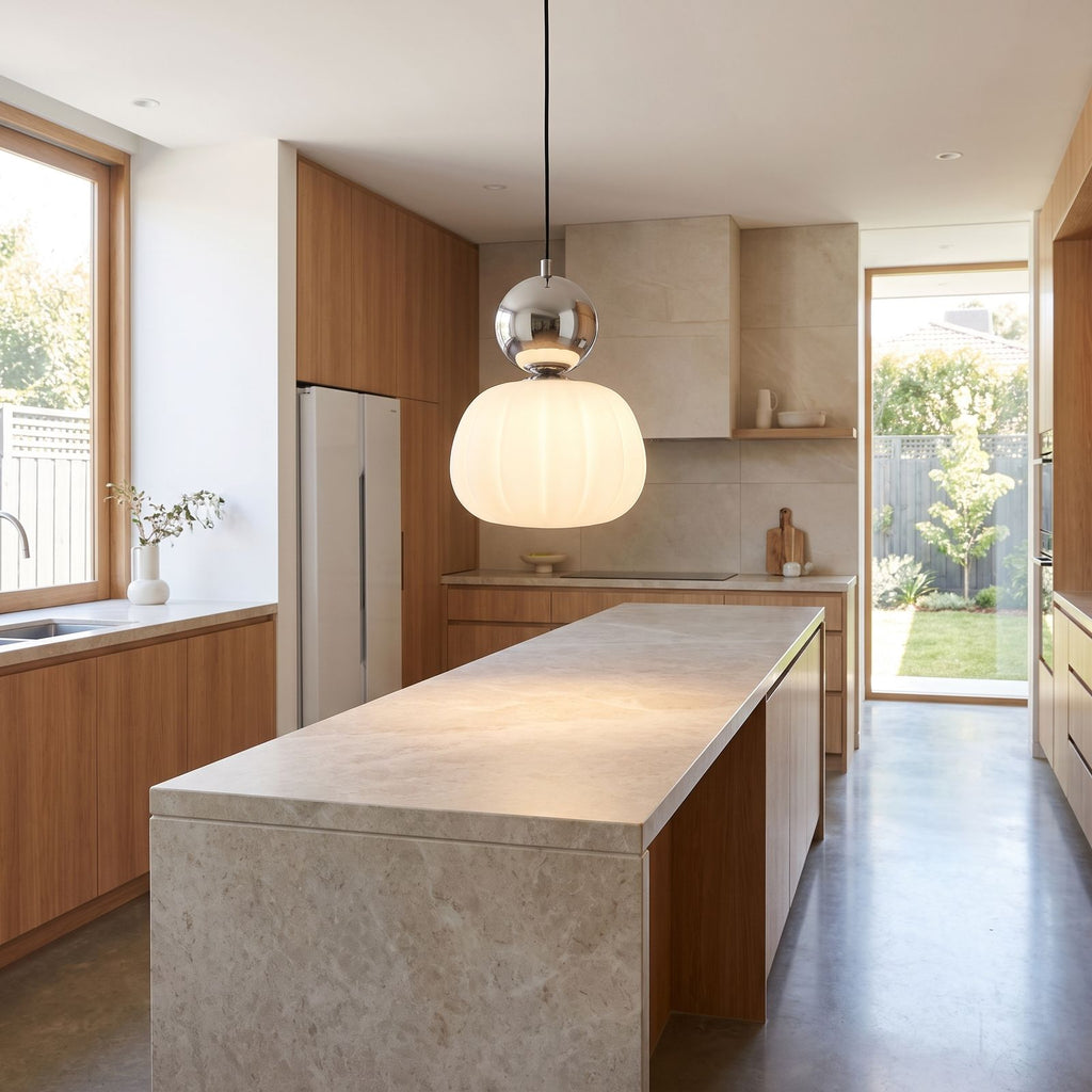 Ball-top scalloped acrylic pendant light over a kitchen island in daylight