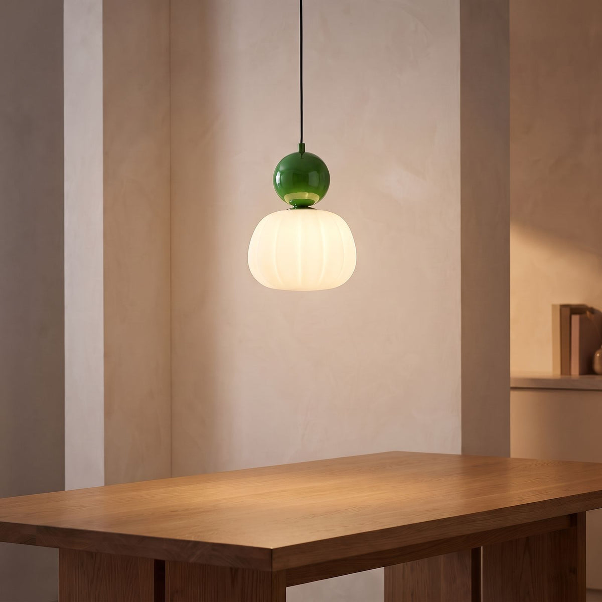 Ball-Top Scalloped Acrylic Pendant Light with a green ball above a dining table