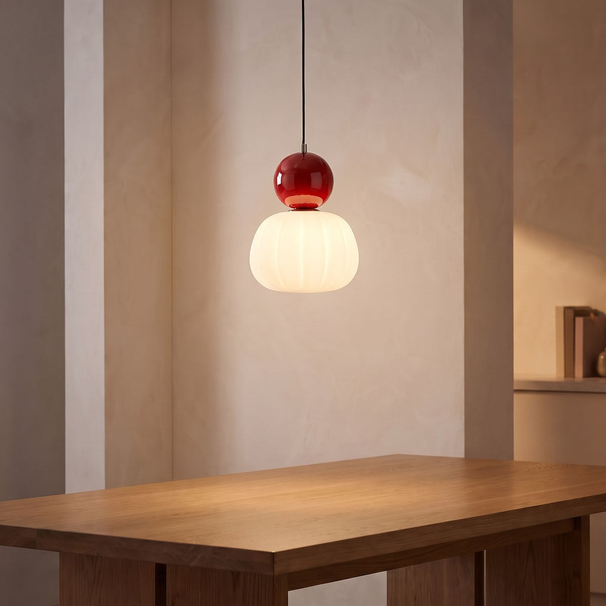 Ball-Top Scalloped Acrylic Pendant Light with a red ball above a dining table