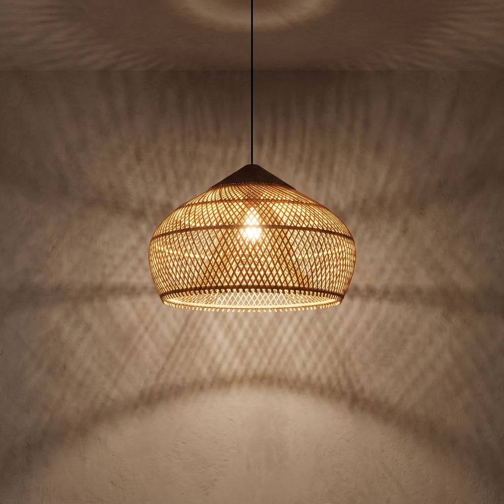 Bamboo Rattan Dome Pendant Light glowing against a plaster wall at night