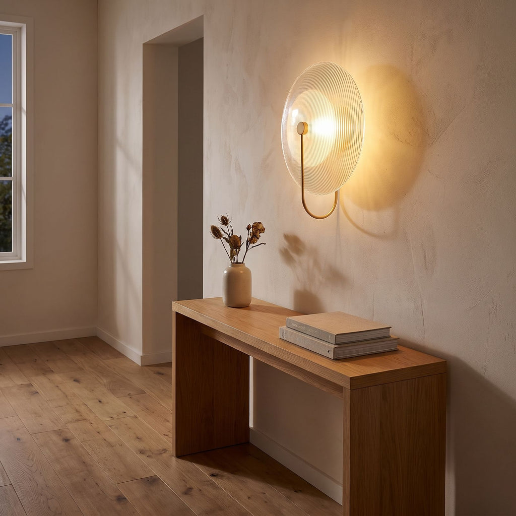 Bent Rod Round Glass Wall Light in a hallway above a timber console