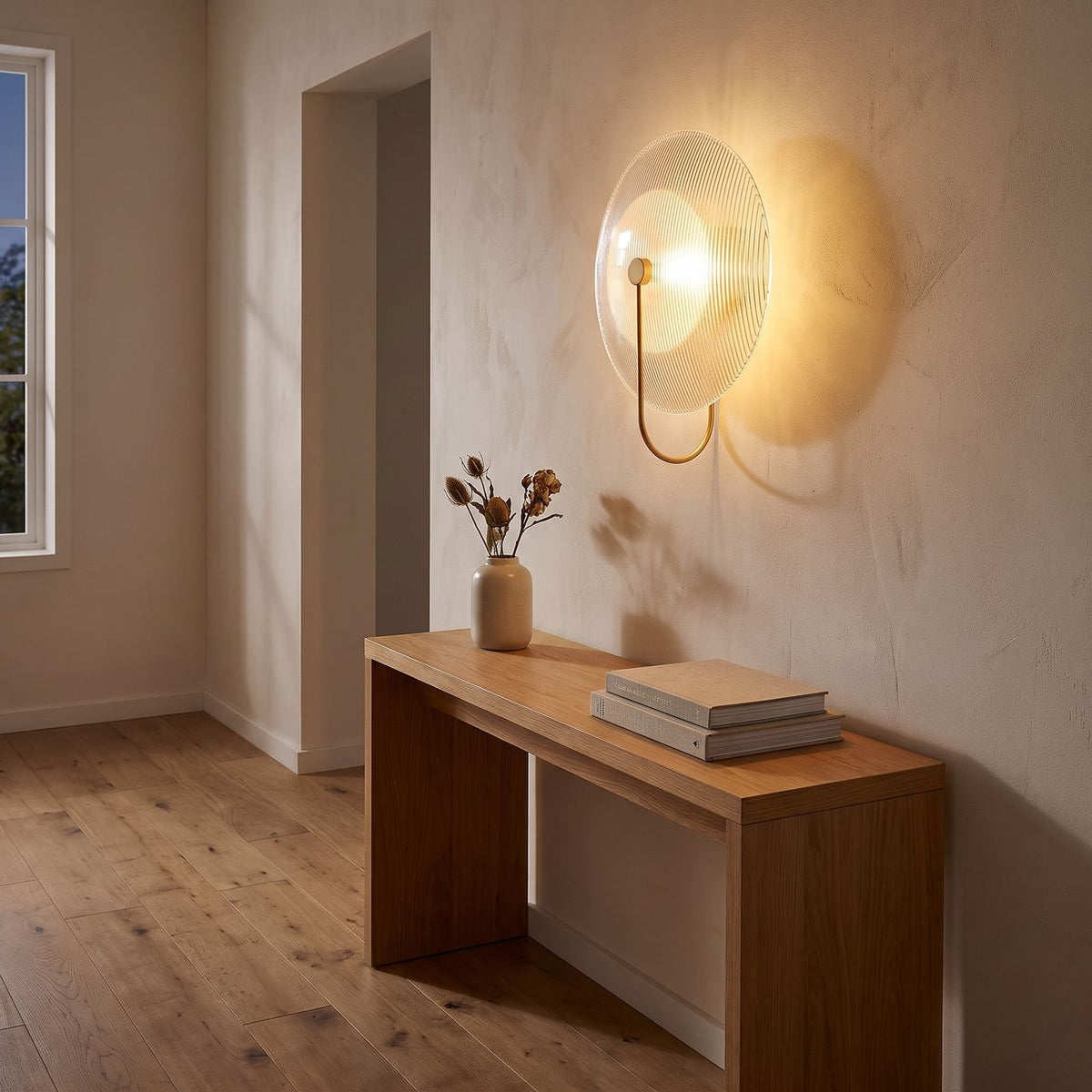 Bent Rod Round Glass Wall Light in a hallway above a timber console