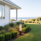 Black Aluminium Cylinder White Diffuser LED Bollard Light beside a driveway in daylight