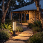 Black Aluminium Cylinder White Diffuser LED Bollard Light lighting a stepping-stone path at night