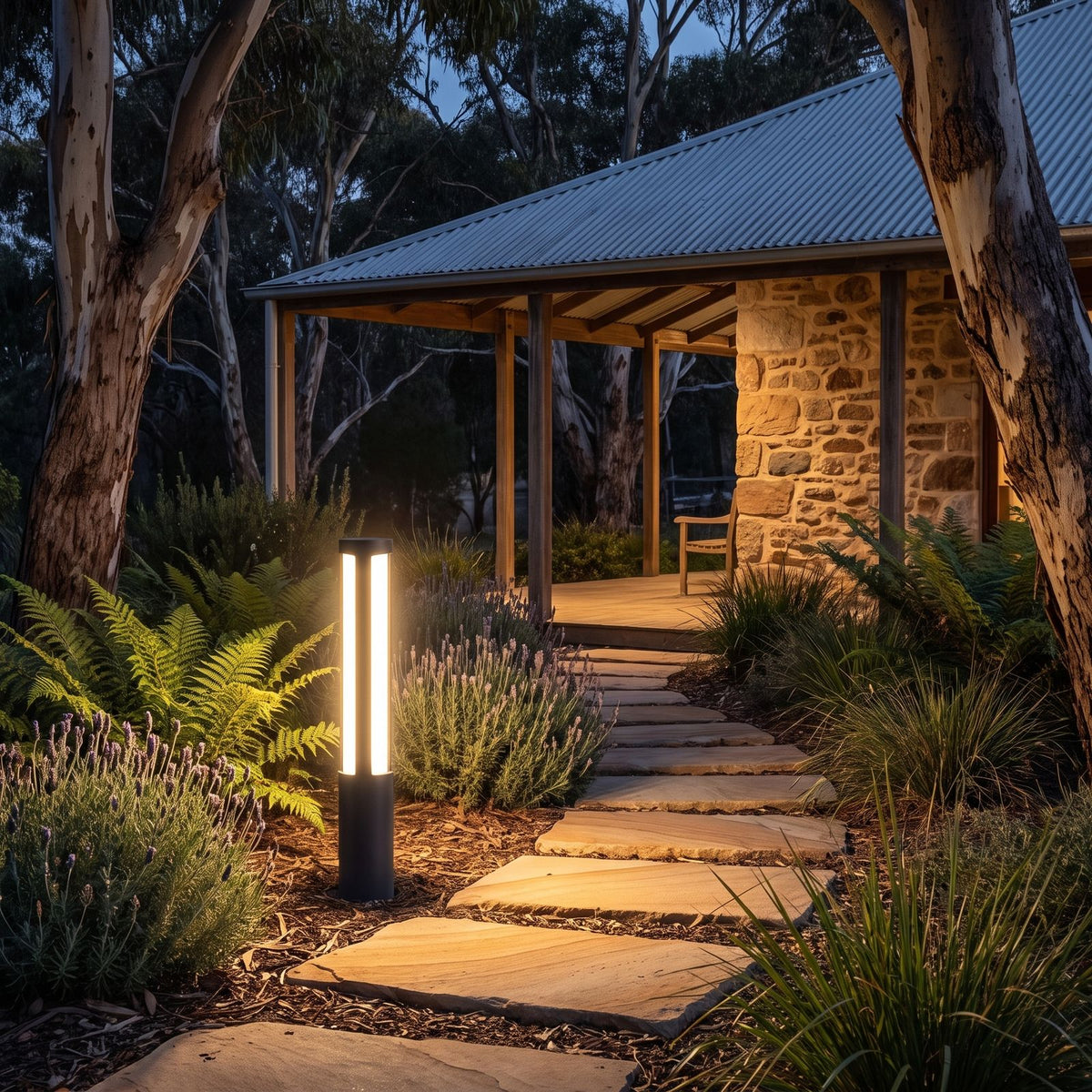 Black Aluminium Cylinder White Diffuser LED Bollard Light lighting a stepping-stone path at night
