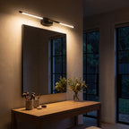 Black and Gold Acrylic Tube LED Vanity Wall Light above the mirror of a makeup table at night