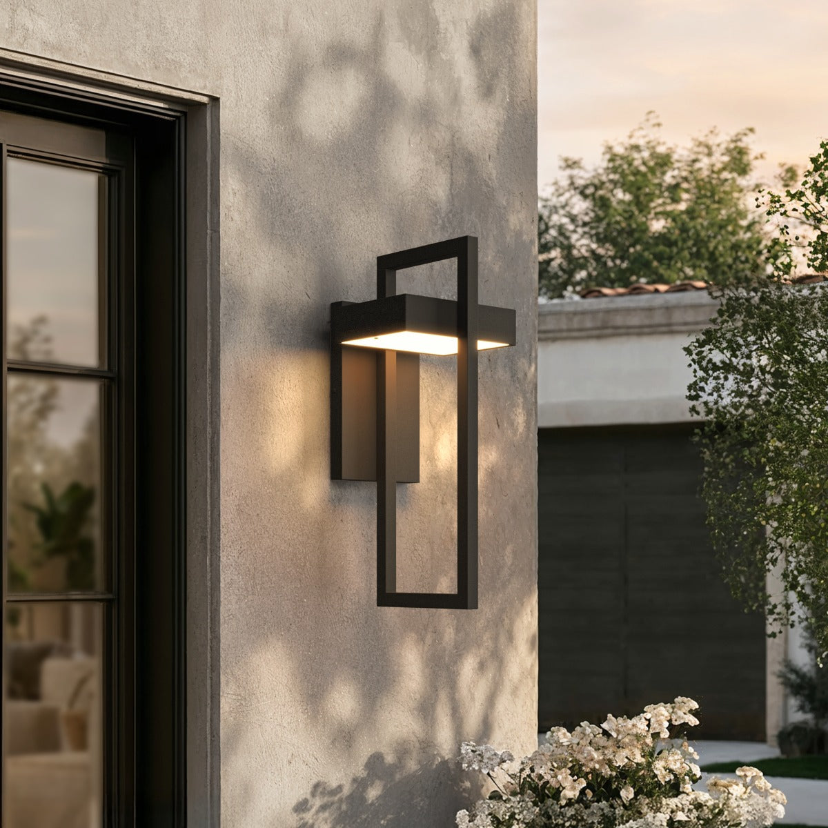 Close view of a black stainless steel outdoor wall sconce at dusk