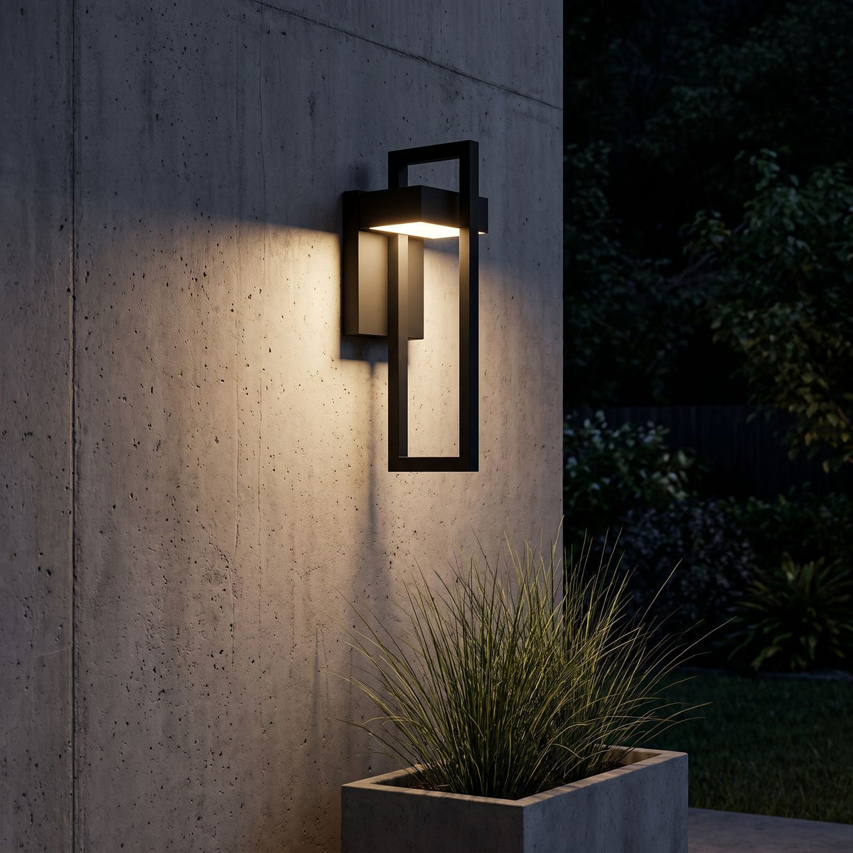 Black Frame Outdoor Wall Sconce lighting a concrete wall at night