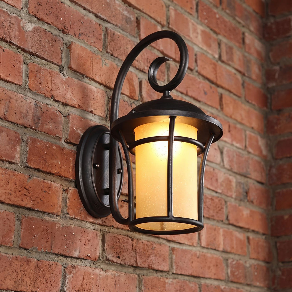 Black Iron and Amber Glass Outdoor Wall Light, close view at 45 degrees on a stone wall