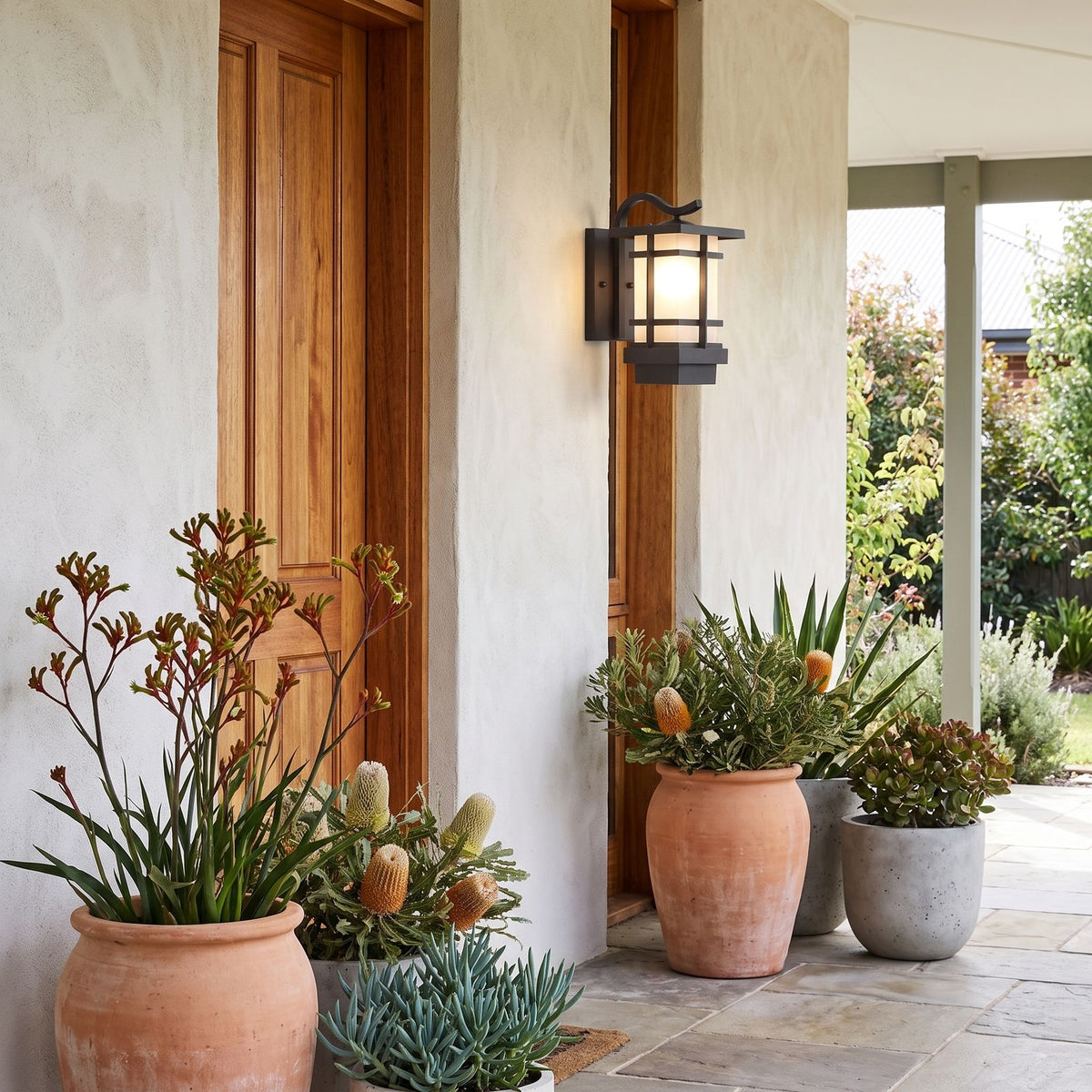 Black Iron and Frosted Glass Outdoor Wall Lantern beside a timber front door