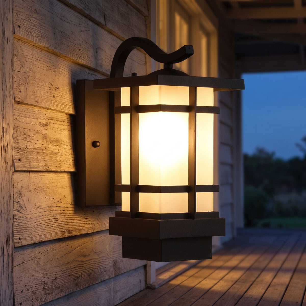 Black Iron and Frosted Glass Outdoor Wall Lantern on a porch wall at dusk