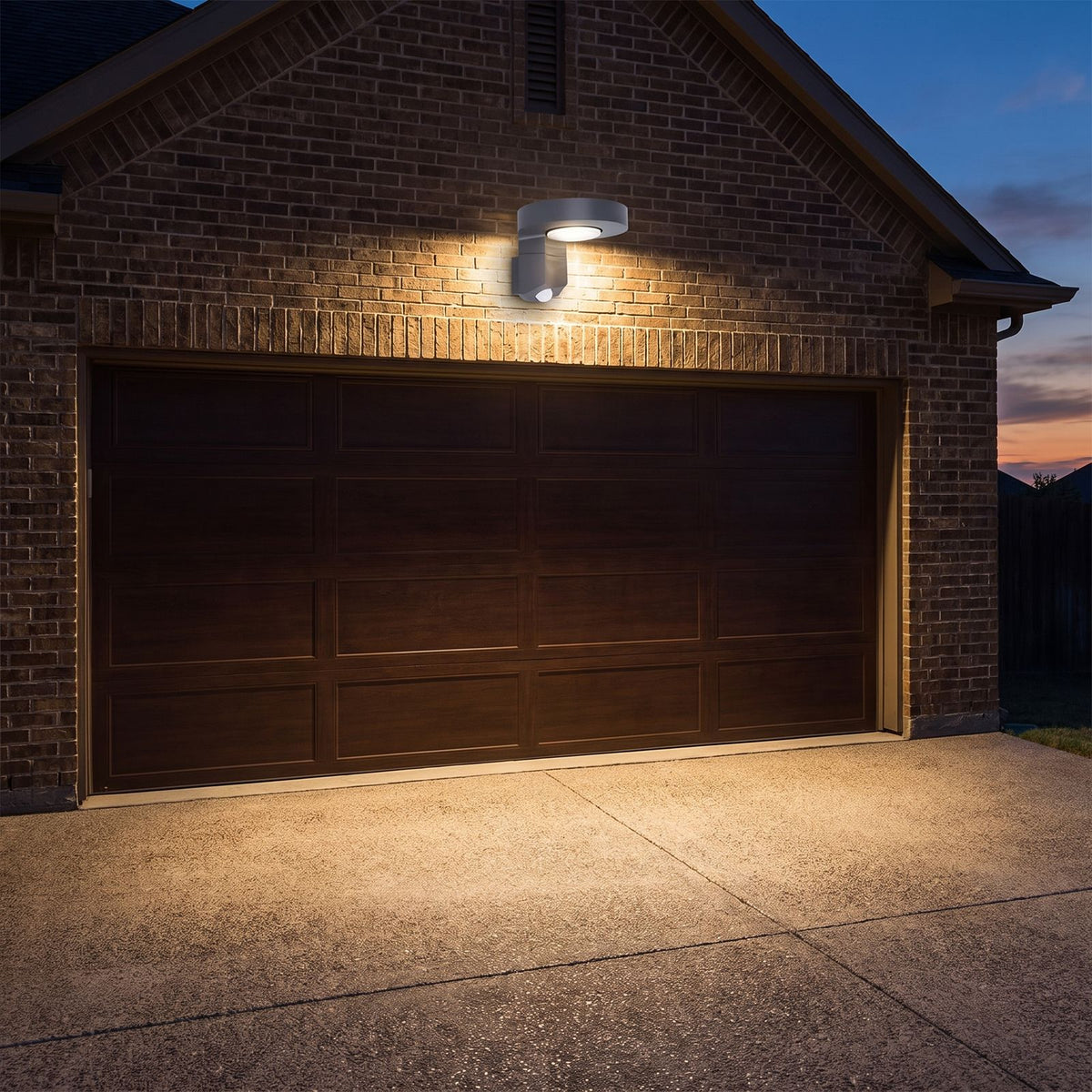 Black Metal and Acrylic Solar Sensor Wall Light on a porch wall at dusk