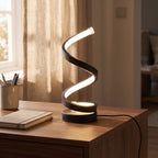 Black spiral ribbon table lamp on a home office desk