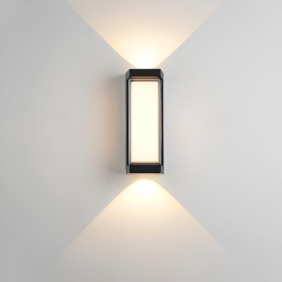 Black up down wall light casting beams above and below on a grey wall