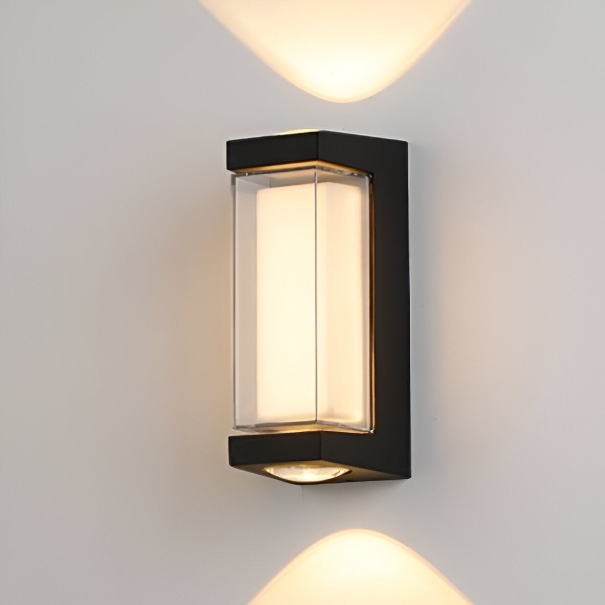 Close view of a black frame up down wall light with frosted body