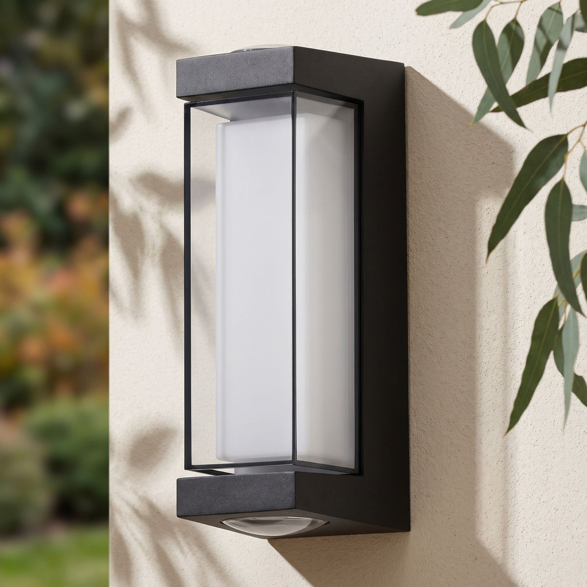 Black Up Down Outdoor Wall Light on a rendered wall, angled close view