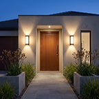 A pair of Black Up Down Outdoor Wall Lights either side of a timber front door