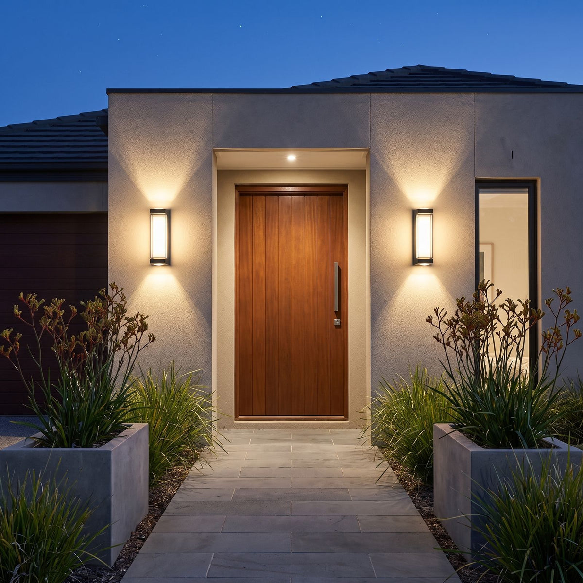 A pair of Black Up Down Outdoor Wall Lights either side of a timber front door