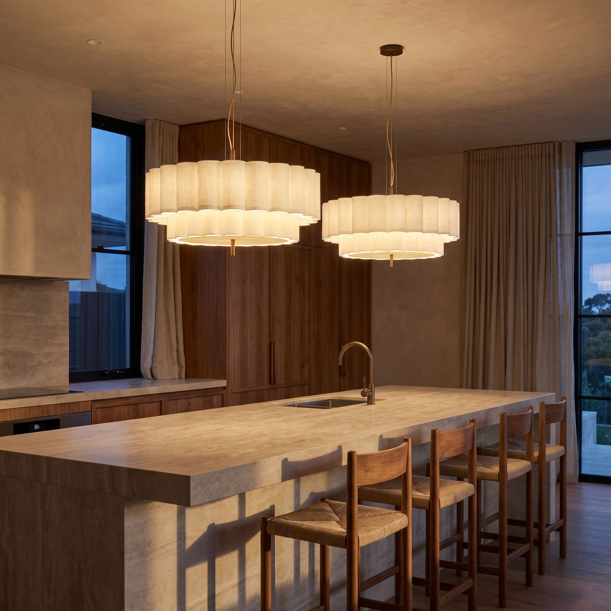 A pair of Boho Knitted Fabric Ripple Pendant Lights over a stone kitchen island