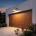 Bowl Shade Gooseneck Outdoor Wall Light above a timber garage door at dusk