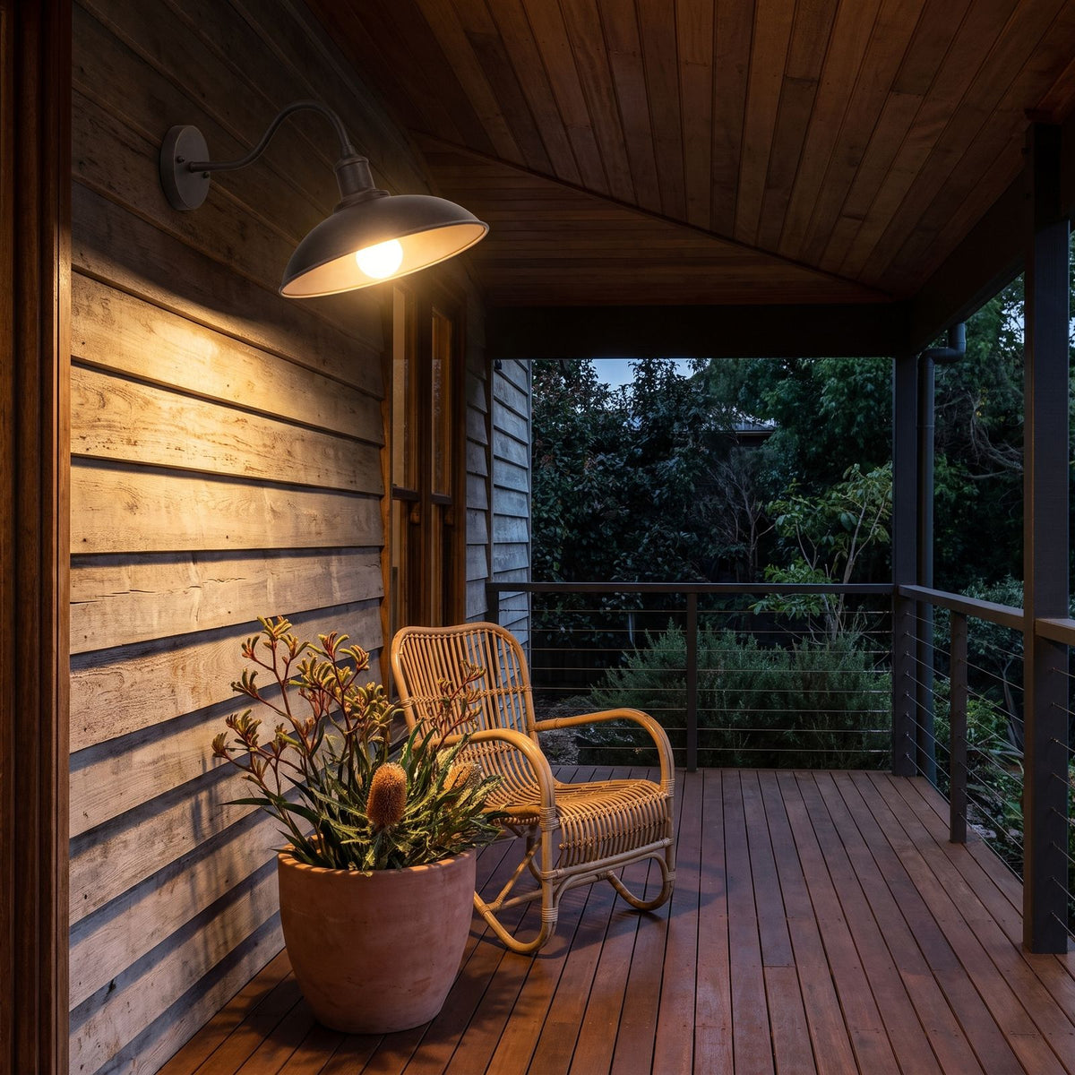 Bowl Shade Gooseneck Outdoor Wall Light on a timber veranda wall at dusk