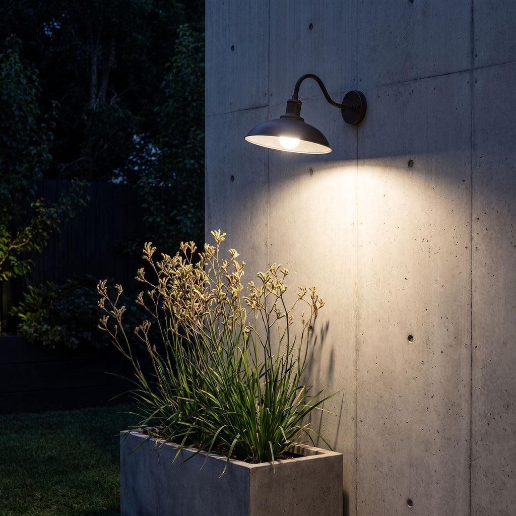 Bowl Shade Gooseneck Outdoor Wall Light lighting a concrete wall at night