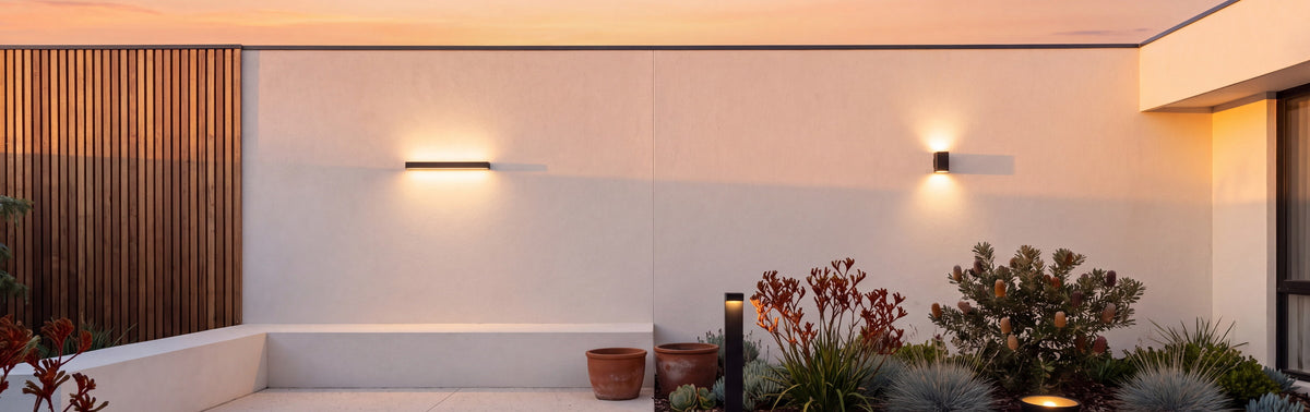 Courtyard at sunset lit by LumePorch wall, bollard and garden lights