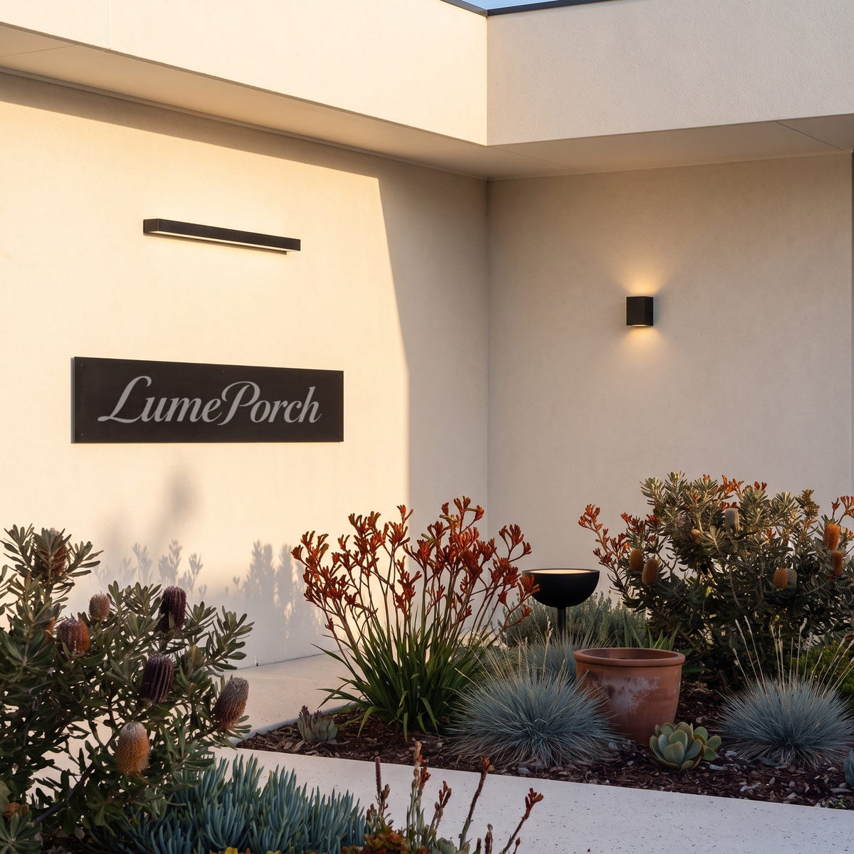 LumePorch nameplate on a courtyard wall beside linear and up-down outdoor wall lights