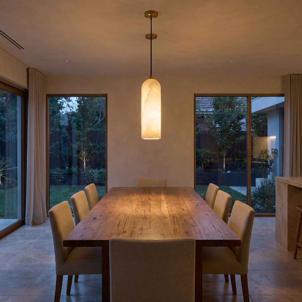 Brass and Alabaster Capsule Pendant Light above a timber dining table