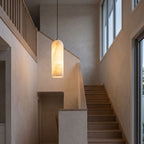 Brass and Alabaster Capsule Pendant Light in a double-height entry foyer