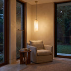 Brass and Alabaster Capsule Pendant Light above an armchair in a reading corner