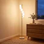 Brass finish opal glass globe floor lamp in a bedroom corner beside a dresser
