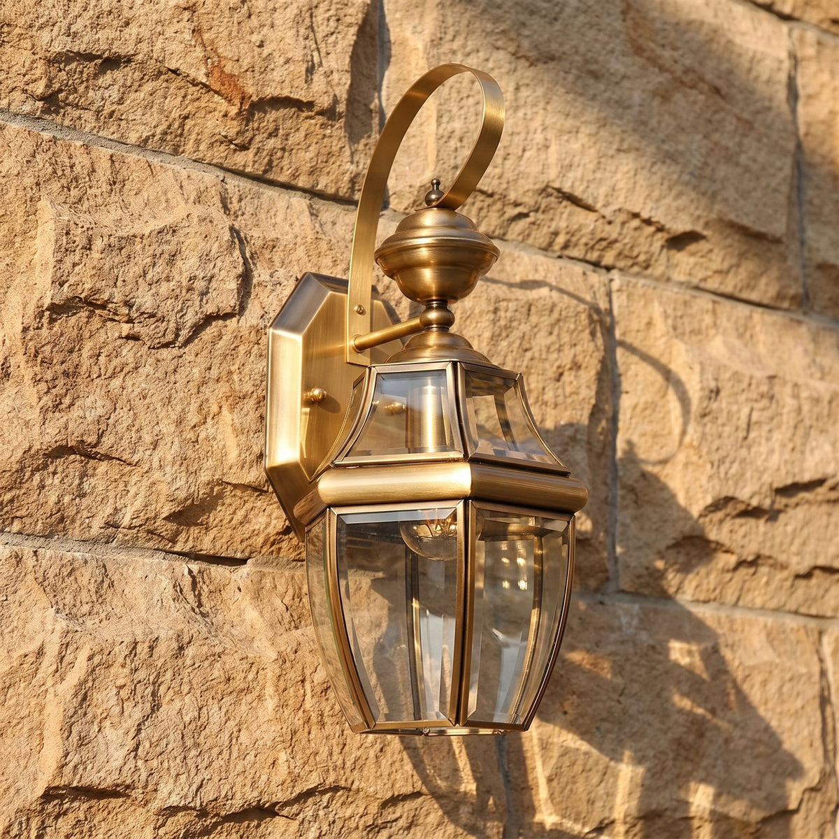 Brass Lantern Outdoor Wall Light, close view at 45 degrees on a stone wall