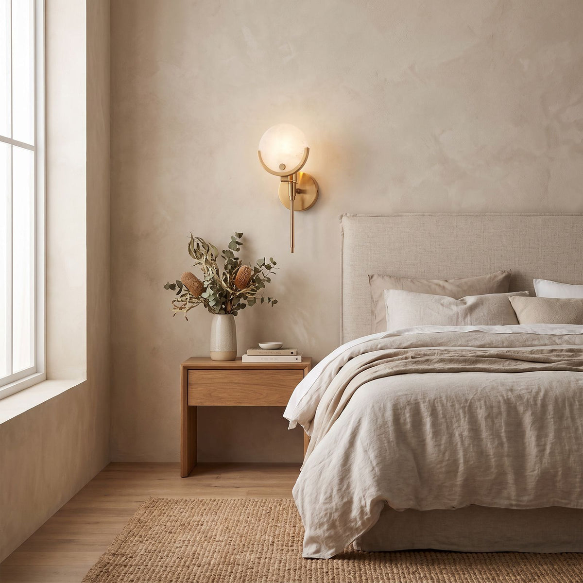Brass Rod Alabaster Globe Wall Light on a bedroom wall beside the bed