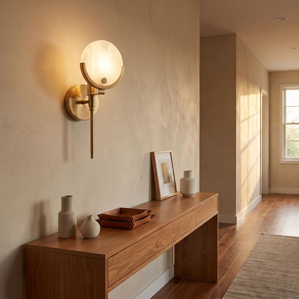 Brass Rod Alabaster Globe Wall Light in a hallway above a timber console
