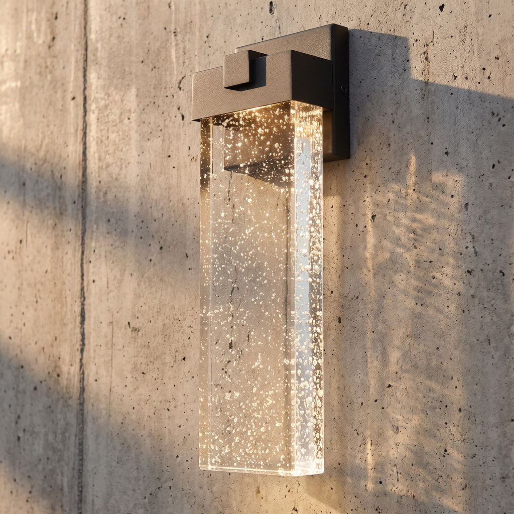 Bubble Acrylic Column Outdoor Wall Light, close view at 45 degrees on a stone wall
