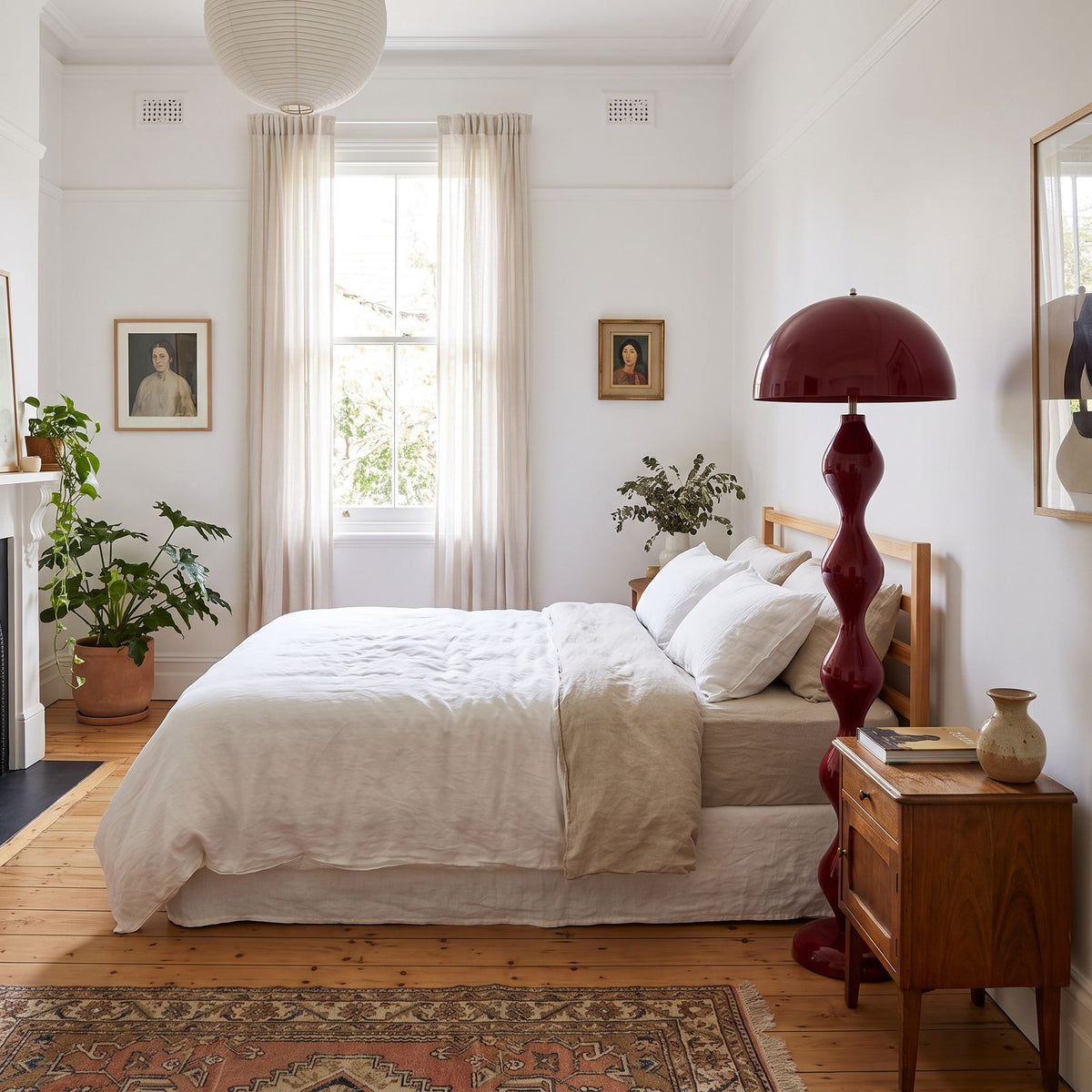 Red bubble stem mushroom floor lamp in the corner of a bright bedroom