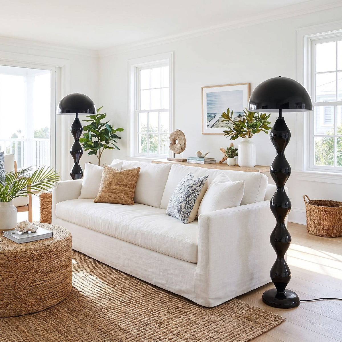 Pair of black mushroom floor lamps at each end of a linen sofa in a coastal living room