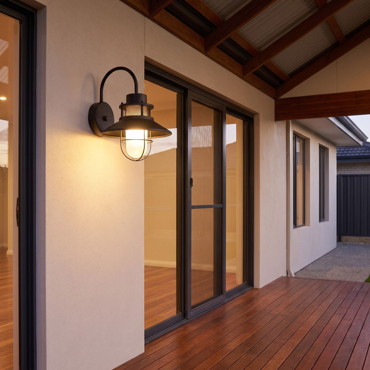 Caged frosted glass gooseneck outdoor wall light on a covered alfresco patio wall