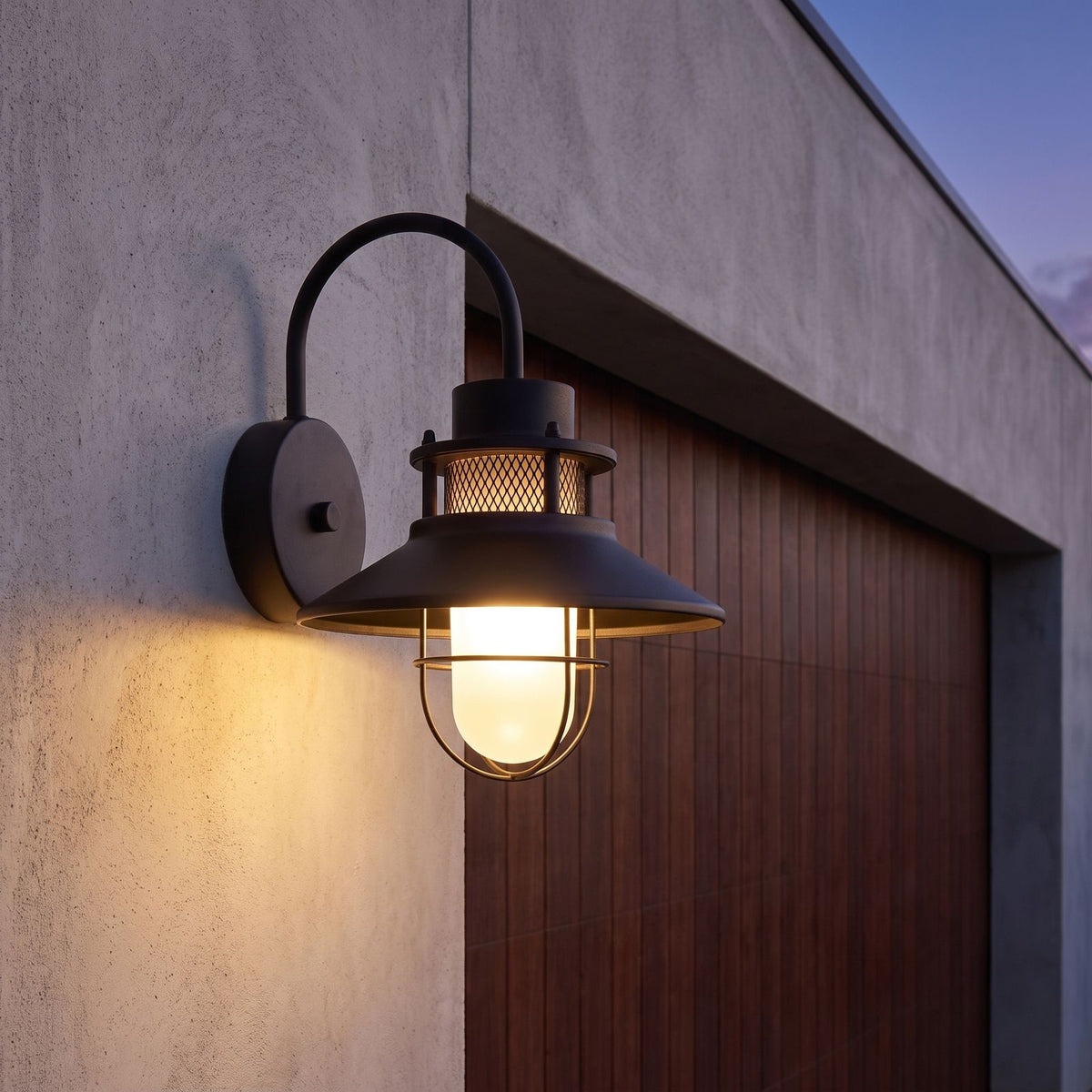Caged frosted glass gooseneck outdoor wall light beside a garage door at dusk