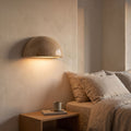 Carved Stone Half Dome LED Wall Light beside a bed