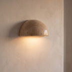 Stone half dome LED wall light on a hallway wall