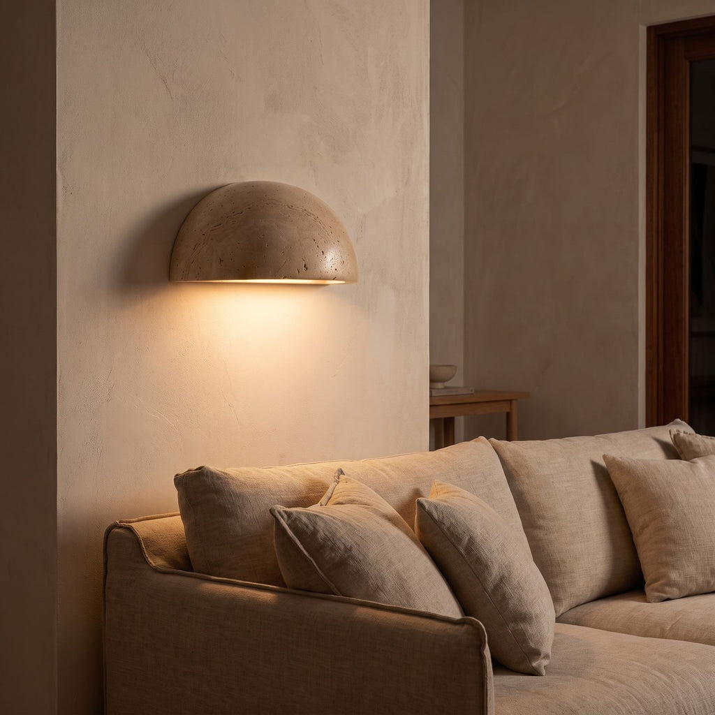 Stone half dome LED wall light beside a living room sofa at night