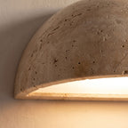Close-up of the porous stone surface and lit underside