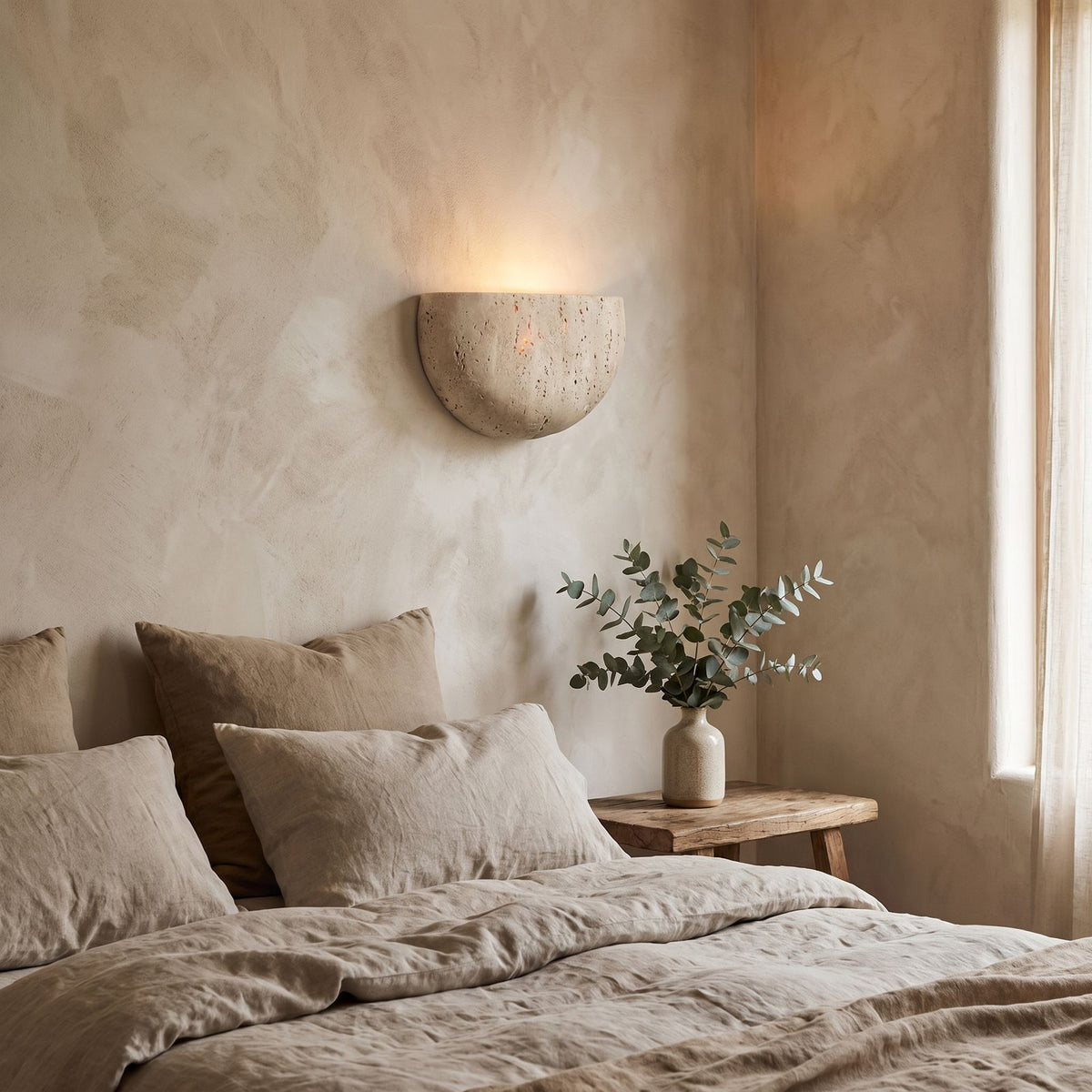 Carved Yellow Travertine Bedside Wall Light on a bedroom wall beside the bed