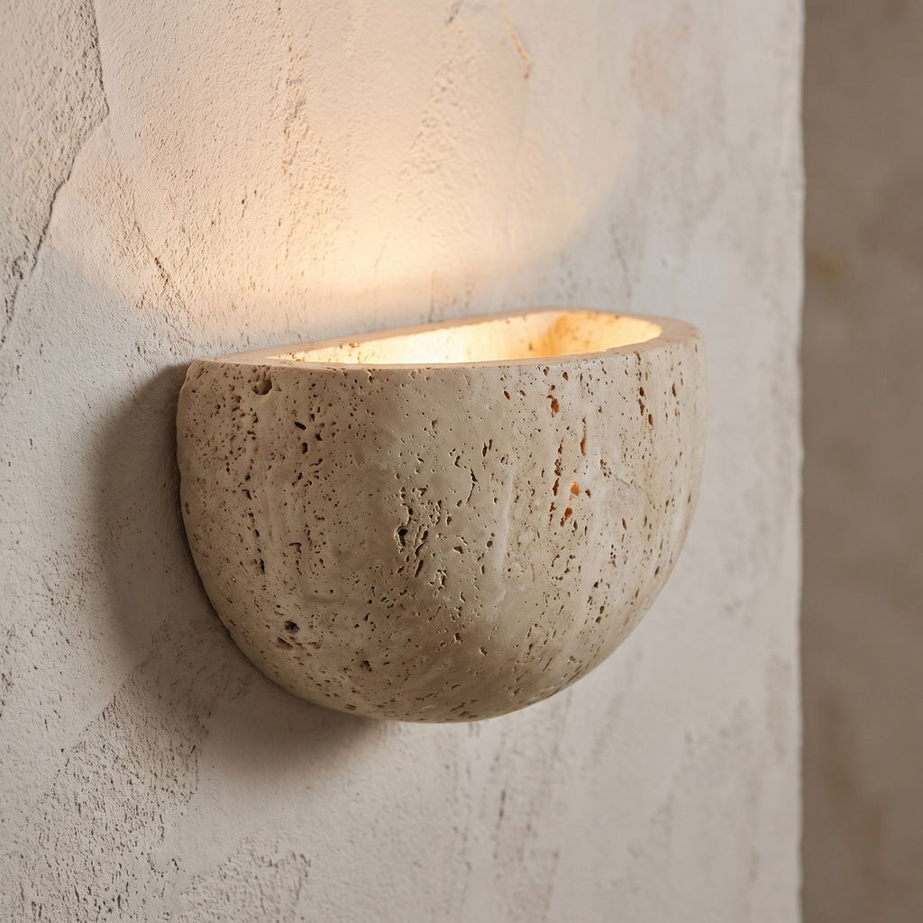 Carved Yellow Travertine Bedside Wall Light, close view at 45 degrees on a plaster wall